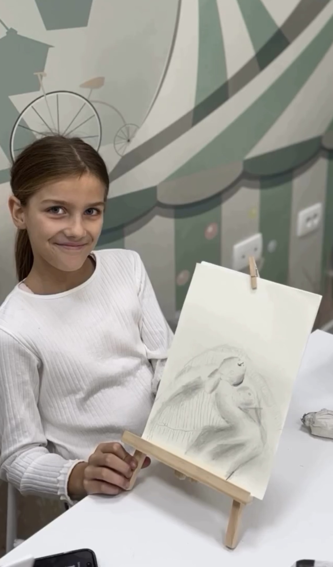 A young student with her charcoal study